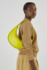 Profile view of model wearing the Oroton Penny Small Shoulder Bag in Bright Chartreuse and Smooth Leather for Women