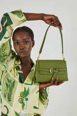 Profile view of model wearing the Oroton Margot Small Top Handle Bag in Ivy and Pebble Leather for Women