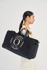 Profile view of model wearing the Oroton Kane Weekender in Black and  for Women