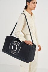 Profile view of model wearing the Oroton Kane Weekender in Black and  for Women