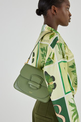 Profile view of model wearing the Oroton Carter Small Day Bag in Shale Green and Smooth Leather for Women