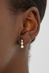 Profile view of model wearing the Oroton Jaclyn Mini Hoops in Worn Gold/White and  for Women