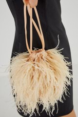 Profile view of model wearing the Oroton Grace Feather Bag in Peach Glow and Polyester Satin for Women