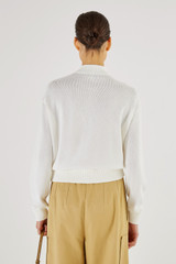 Profile view of model wearing the Oroton Mesh Stitch Bomber in White and 83% Viscose 17% Polyester for Women