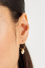 Profile view of model wearing the Oroton Nellie Hoops in Gold/White and  for Women