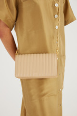 Profile view of model wearing the Oroton Fay Medium Chain Crossbody in Sand and Nappa Leather for Women