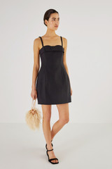Profile view of model wearing the Oroton Bodice Detail Mini Dress in Black and 61% Cotton, 39% Polyester for Women