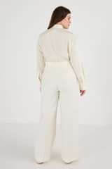 Profile view of model wearing the Oroton Flat Fronted Pant in Cream and 53% Polyester 43% Wool 4% Elastane for Women