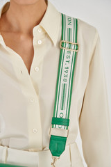Profile view of model wearing the Oroton Heather Webbing Strap in Emerald/Cream and Polyester Webbing And Saffiano Leather Trim for Women
