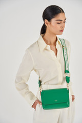 Profile view of model wearing the Oroton Heather Webbing Strap in Emerald/Cream and Polyester Webbing And Saffiano Leather Trim for Women