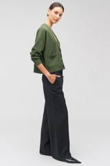Profile view of model wearing the Oroton Flat Front Pant in Black and 53% polyester, 42% virgin wool, 5% elastane for Women