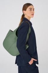 Profile view of model wearing the Oroton Emilia Tote in Moss and Pebble Leather for Women