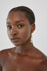 Profile view of model wearing the Oroton Clementine Drop Earrings in Worn Gold and  for Women