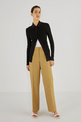 Profile view of model wearing the Oroton Pintuck Pant in Tobacco and 58% Viscose 42% Linen for Women