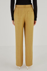 Profile view of model wearing the Oroton Pintuck Pant in Tobacco and 58% Viscose 42% Linen for Women