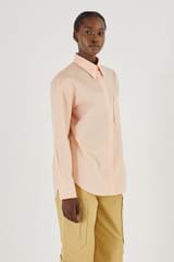 Profile view of model wearing the Oroton Poplin Long Sleeve Shirt in Iced Pink and 100% Cotton for Women