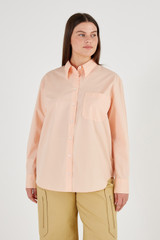 Profile view of model wearing the Oroton Poplin Long Sleeve Shirt in Iced Pink and 100% Cotton for Women