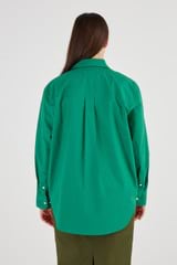 Profile view of model wearing the Oroton Poplin Long Sleeve Shirt in Holly and 100% Cotton for Women
