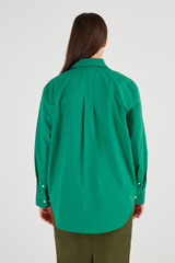 Profile view of model wearing the Oroton Poplin Long Sleeve Shirt in Holly and 100% Cotton for Women