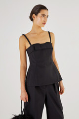 Profile view of model wearing the Oroton Bodice Top in Black and 61% Cotton, 39% Polyester for Women