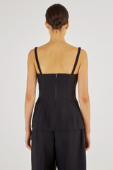 Profile view of model wearing the Oroton Bodice Top in Black and 61% Cotton, 39% Polyester for Women