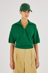 Profile view of model wearing the Oroton Mesh Stitch Polo in Kelly Green and 83% Viscose 17% Polyester for Women