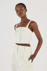 Profile view of model wearing the Oroton Button Detail Bodice in Cream and 77% Cotton 23% Linen for Women
