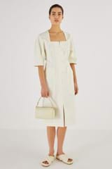 Profile view of model wearing the Oroton Long Line Utility Dress in Cream and 77% Cotton 23% Linen for Women