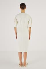 Profile view of model wearing the Oroton Long Line Utility Dress in Cream and 77% Cotton 23% Linen for Women