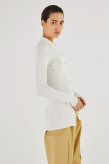 Profile view of model wearing the Oroton Long Sleeve Rib Cardi in Cream and 77% Viscose 23 % Polyester for Women