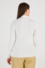 Profile view of model wearing the Oroton Long Sleeve Rib Cardi in Cream and 77% Viscose 23 % Polyester for Women