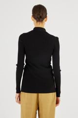 Profile view of model wearing the Oroton Long Sleeve Rib Cardi in Black and 77% Viscose 23 % Polyester for Women