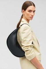 Profile view of model wearing the Oroton Penny Hobo in Black and Smooth leather for Women