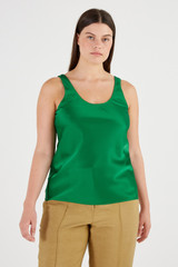 Profile view of model wearing the Oroton Fluid Satin Tank in Kelly Green and 80% Acetate, 20% Polyester for Women