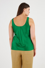 Profile view of model wearing the Oroton Fluid Satin Tank in Kelly Green and 80% Acetate, 20% Polyester for Women