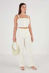 Profile view of model wearing the Oroton Zip Detail Pant in Cream and 77% Cotton 23% Linen for Women