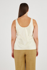 Profile view of model wearing the Oroton Fluid Satin Tank in Vanilla Bean and 80% Acetate, 20% Polyester for Women