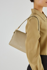 Profile view of model wearing the Oroton Alice Crossbody in Clay and Pebble Leather for Women