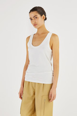 Profile view of model wearing the Oroton Knit Tank in White and 83% Viscose, 17% Polyester for Women