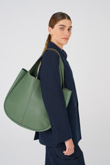 Profile view of model wearing the Oroton Emilia Large Tote in Moss and Pebble Leather for Women