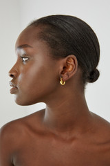 Profile view of model wearing the Oroton Mimi Mini Huggies in Worn Gold and  for Women