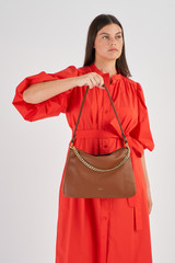 Profile view of model wearing the Oroton Asha Medium Hobo in Whiskey and Pebble Leather for Women