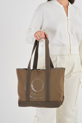 Profile view of model wearing the Oroton Kane Small Shopper Tote in Khaki and Recycled Canvas for Women