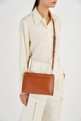 Profile view of model wearing the Oroton Harvey Double Zip Crossbody in Cognac and Smooth Leather for Women