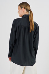 Profile view of model wearing the Oroton Contrast Colour Blouse in Black and 92% Silk 8% Spandex for Women
