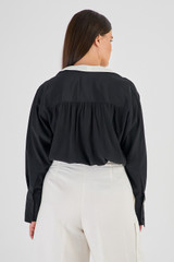 Profile view of model wearing the Oroton Contrast Colour Blouse in Black and 92% Silk 8% Spandex for Women