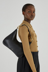Profile view of model wearing the Oroton North Hobo in Black and Smooth Leather for Women