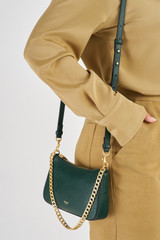 Profile view of model wearing the Oroton Asha Baguette Crossbody in Juniper and Pebble Leather for Women