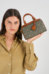 Profile view of model wearing the Oroton Harvey Signature Mini Barrel Bag in Black/Cognac and Printed Coated Canvas With Leather Trims for Women