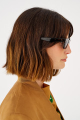 Profile view of model wearing the Oroton Sunglasses Wilder in Signature Tort and Acetate for Women